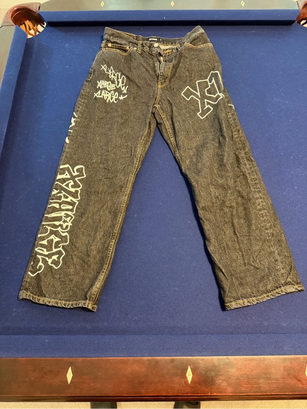 Relaxed Black Men's Jeans with White Graffiti Accents